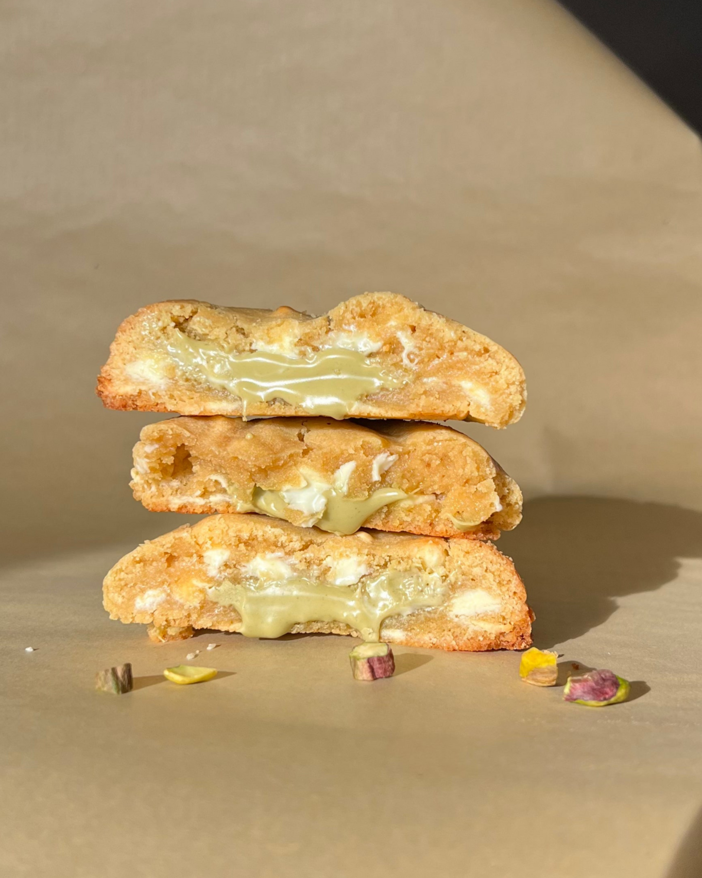 Stack of cookies on a textured surface with a warm color tone